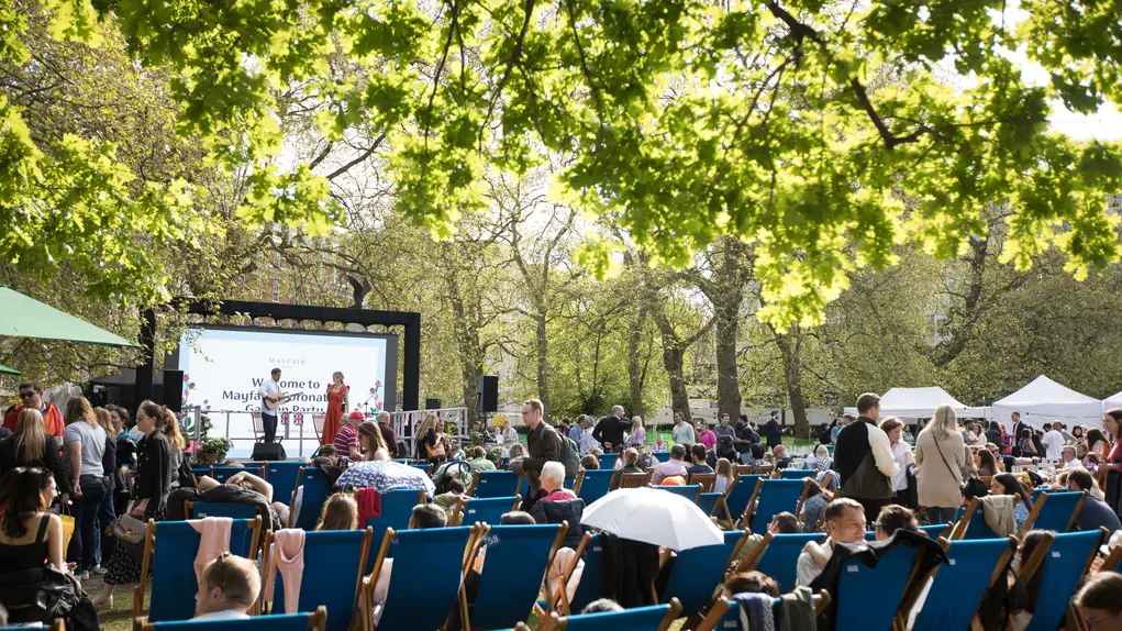 People on deckchairs facing a big screen in Grosvenor Square