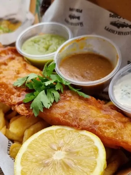 Fish and chips with a lemon and three sauces