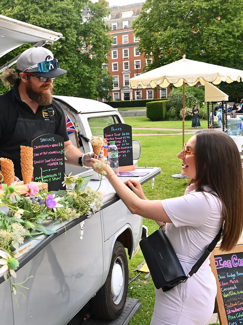 Woman buys ice cream from ice-cream cart