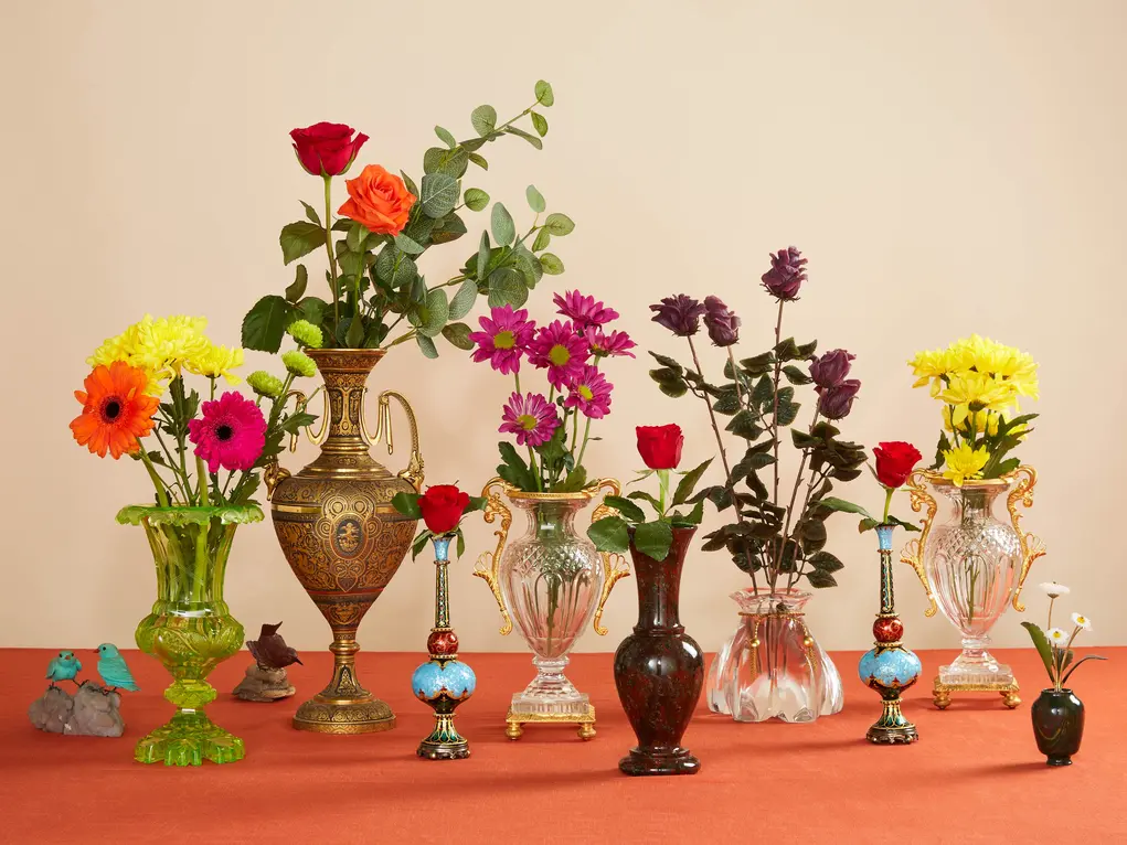 Lots of vases containing flowers