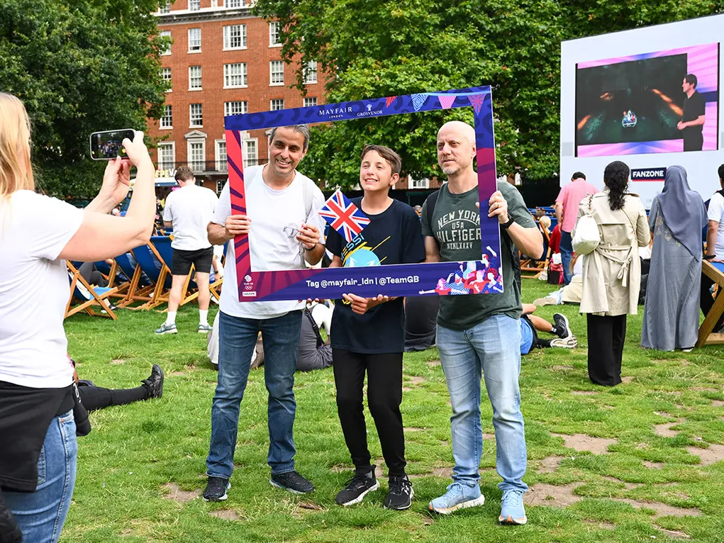 Three people taking a selfie in a huge picture frame